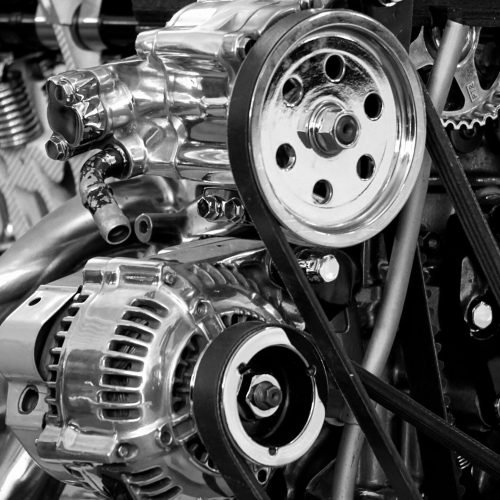 Home Close-up of a shiny car engine showing polished metal parts and gears in black and white.